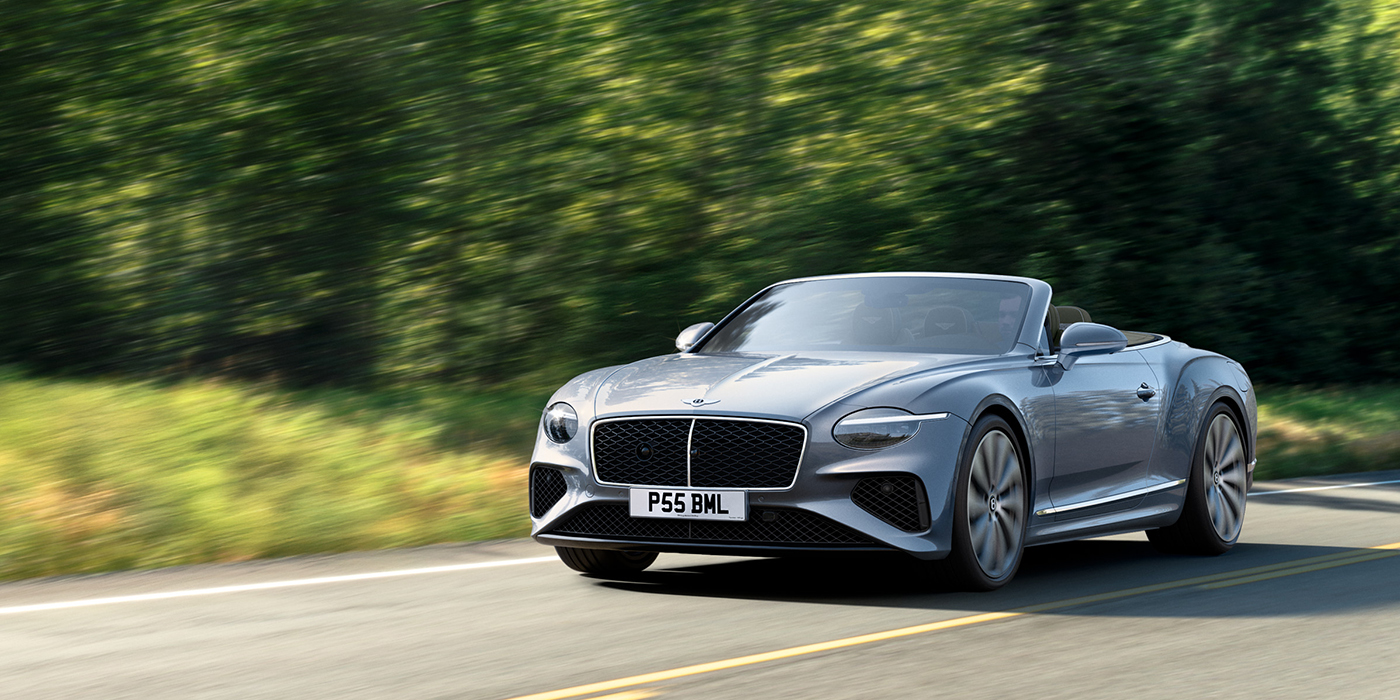 Bentley Kaohsiung New Bentley Continental GTC convertible front view in Silverlake paint with 22 inch ten spoke wheels, driving dynamically on a country road