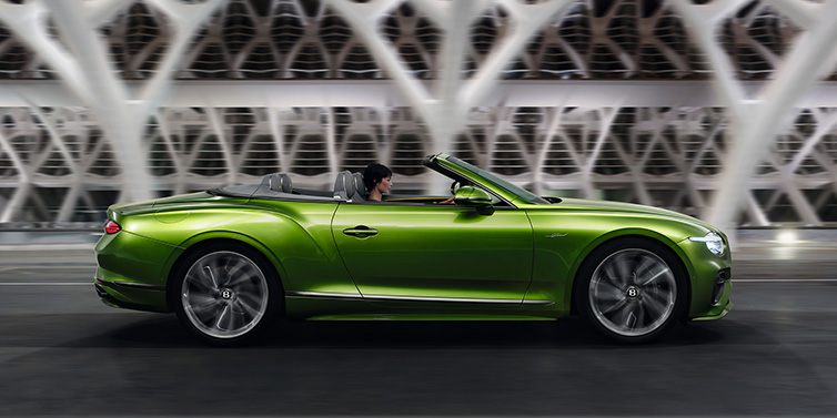 Bentley Kaohsiung Bentley Continental GTC Speed convertible side profile in Tourmaline Green paint driving dynamically on a bridge at night