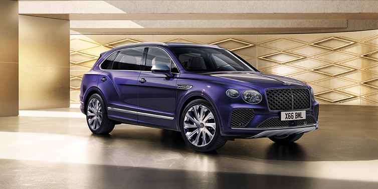 Bentley Kaohsiung Bentley Bentayga Extended Wheelbase Mulliner SUV front three quarter in Tanzanite Purple paint with a gold patterned background