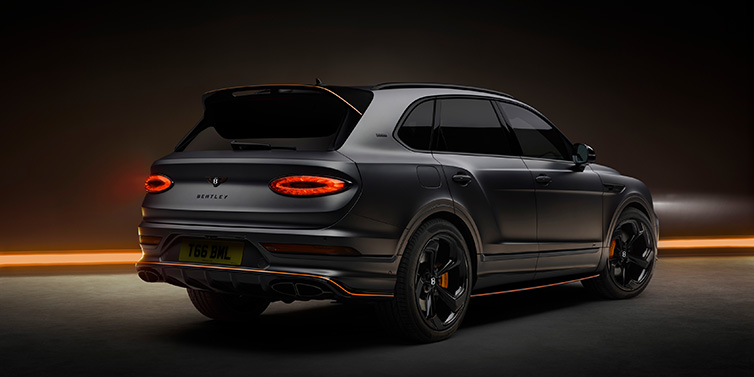 Bentley Kaohsiung Bentley Bentayga S Black Edition SUV rear three quarter in Anthracite Satin paint against a dark red and yellow background