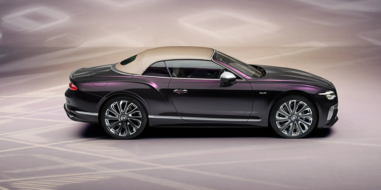 Bentley Kaohsiung Bentley Continental GTC Mulliner convertible in profile with hood up, in Tanzanite Purple paint and 22 inch Mulliner painted and polished wheels