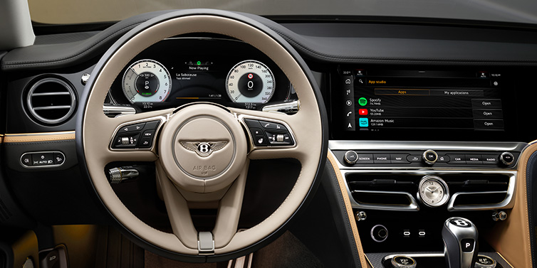 Bentley Kaohsiung Bentley Flying Spur Mulliner sedan front interior detail of steering wheel and driver screens surrounded by Linen and Beluga black hides