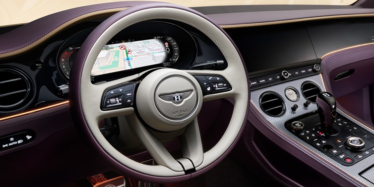 Bentley Kaohsiung Bentley Continental GT Mulliner coupe front interior showing steering wheel and drivers screens surrounded by Linen and Damson hides and Grand Black veneer